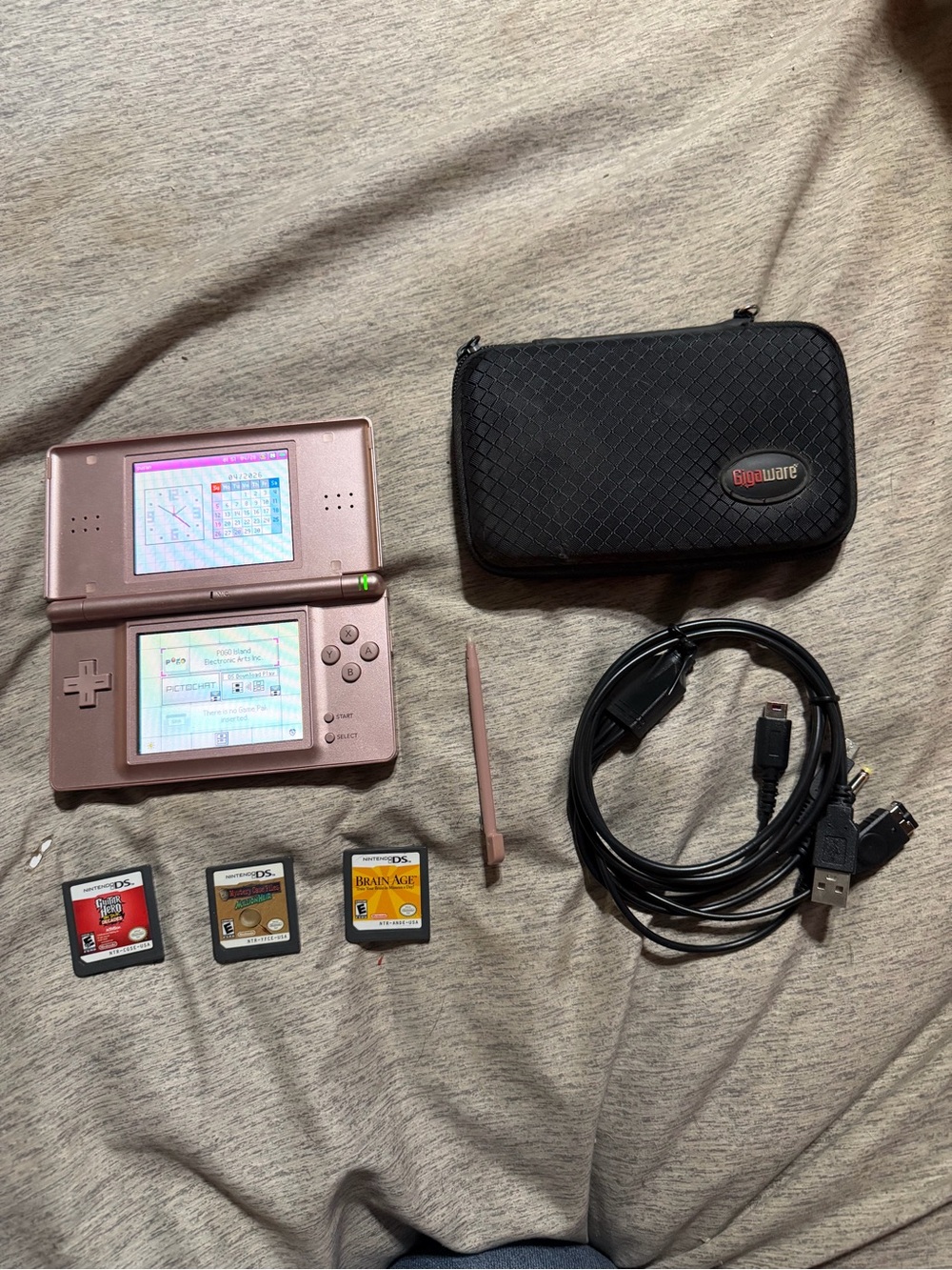 Nintendo DS Rose Pink Handheld Console with Stylus and Games and charge cord.